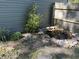 Charming backyard water feature, framed with rocks and greenery, creates a relaxing and serene outdoor space at 7824 Inverness Dr, Indianapolis, IN 46237