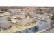 Aerial view of brick homes with a water feature winding through the community at 8545 Olde Ml Trce, Indianapolis, IN 46260