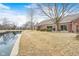 Lush backyard with a patio and scenic pond view at 8545 Olde Ml Trce, Indianapolis, IN 46260