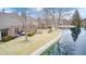 Scenic backyard view of home with water feature, landscaped lawn and stone retaining wall at 8545 Olde Ml Trce, Indianapolis, IN 46260