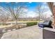 Backyard patio area overlooking peaceful pond with mature trees; serene outdoor space at 8545 Olde Ml Trce, Indianapolis, IN 46260