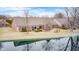 Backyard view of a brick home overlooking a serene water feature with patio space at 8545 Olde Ml Trce, Indianapolis, IN 46260