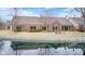 Water view with a meticulously maintained lawn and patio area, ideal for outdoor enjoyment at 8545 Olde Ml Trce, Indianapolis, IN 46260
