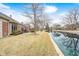 Waterfront backyard with a well-manicured lawn leading to a serene pond, perfect for relaxation at 8545 Olde Ml Trce, Indianapolis, IN 46260