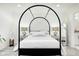 Bright bedroom featuring a stylish canopy bed, modern nightstands, and fresh, neutral decor at 8545 Olde Ml Trce, Indianapolis, IN 46260