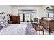 Bedroom featuring an iron bed frame, natural light from bay window, dresser, and warm rug at 8545 Olde Ml Trce, Indianapolis, IN 46260