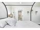 Bright bedroom showcasing stylish canopy bed, fresh, neutral decor, and an ensuite bathroom at 8545 Olde Ml Trce, Indianapolis, IN 46260