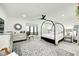 Serene bedroom with a large window, neutral decor, and an elegant canopy bed at 8545 Olde Ml Trce, Indianapolis, IN 46260