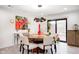 Dining room features a round table with seating for six, a modern light fixture, and sliding door to the backyard at 8545 Olde Ml Trce, Indianapolis, IN 46260