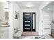 Elegant foyer with modern lighting, tiled flooring, and a stylish entry door at 8545 Olde Ml Trce, Indianapolis, IN 46260