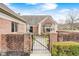 Charming gated entrance featuring a brick wall and pathway to the front door at 8545 Olde Ml Trce, Indianapolis, IN 46260