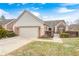 Charming brick home with a two-car garage, manicured landscaping, and inviting curb appeal at 8545 Olde Ml Trce, Indianapolis, IN 46260