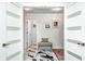 Hallway featuring black-and-white marble-patterned tile, a decorative bench seat, and eye-catching artwork at 8545 Olde Ml Trce, Indianapolis, IN 46260