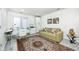 Bright home office features a stylish desk, storage cabinet, and comfortable olive-green couch on a patterned rug at 8545 Olde Ml Trce, Indianapolis, IN 46260