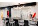 Open kitchen features a granite counter top, black cabinetry, and an elegant decorative chandelier at 8545 Olde Ml Trce, Indianapolis, IN 46260
