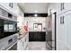 Stylish white kitchen with black hardware, granite countertops, and stainless steel appliances at 8545 Olde Ml Trce, Indianapolis, IN 46260