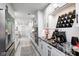 Modern kitchen with white cabinetry, black hardware, and black and white backsplash accent at 8545 Olde Ml Trce, Indianapolis, IN 46260