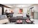 Spacious living room with dark couch, decorative ottoman, and views of the kitchen and dining areas at 8545 Olde Ml Trce, Indianapolis, IN 46260