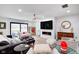Open-concept living room with comfortable seating, fireplace, ceiling fan, and backyard access through sliding doors at 8545 Olde Ml Trce, Indianapolis, IN 46260