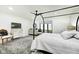 Main bedroom featuring four poster bed, modern furniture and an area rug at 8545 Olde Ml Trce, Indianapolis, IN 46260