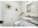 Stylish powder room with granite countertop, modern sink and faucet, decorative mirror and light fixtures at 8545 Olde Ml Trce, Indianapolis, IN 46260