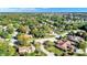 This aerial view showcases the tree-filled neighborhood where the home sits, dotted with well-maintained houses at 908 Whispering Trl, Greenfield, IN 46140