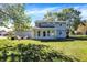 Spacious backyard with a sunroom addition, providing ample space for outdoor activities and relaxation at 908 Whispering Trl, Greenfield, IN 46140
