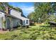Expansive backyard featuring a lush lawn, mature trees, and a charming two-story home with a cozy sunroom at 908 Whispering Trl, Greenfield, IN 46140
