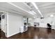 Partially finished basement with hardwood floors, shelving, and a bright, open layout at 908 Whispering Trl, Greenfield, IN 46140