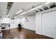Basement features hardwood flooring, ample lighting, and a dedicated workspace area at 908 Whispering Trl, Greenfield, IN 46140