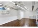 Large basement area featuring hardwood floors, built-in shelving, and ample lighting at 908 Whispering Trl, Greenfield, IN 46140