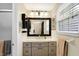 Bathroom featuring modern vanity, large framed mirror, and updated lighting fixtures at 908 Whispering Trl, Greenfield, IN 46140