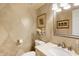 Elegant half bathroom features decorative wallpaper, mirror, and vanity sink at 908 Whispering Trl, Greenfield, IN 46140