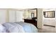 Bedroom with a bed, dresser, large mirror, and adjacent bathroom featuring updated vanity at 908 Whispering Trl, Greenfield, IN 46140