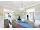 This dining room features a decorative chandelier, table with seating for four and views to the kitchen and living room at 908 Whispering Trl, Greenfield, IN 46140