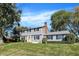 Charming two-story home with light gray siding, black shutters, and a bright yellow front door at 908 Whispering Trl, Greenfield, IN 46140