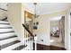 Inviting foyer featuring hardwood floors, stairs, and a view into a home office at 908 Whispering Trl, Greenfield, IN 46140