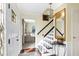 Inviting foyer with hardwood floors and stairs to the second floor at 908 Whispering Trl, Greenfield, IN 46140