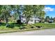 Classic two-story home with mature trees, a green lawn, and black shutters offering curb appeal at 908 Whispering Trl, Greenfield, IN 46140