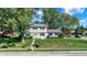 Well-kept two-story home featuring classic siding, a bright yellow front door, and a lush green lawn with mature trees at 908 Whispering Trl, Greenfield, IN 46140