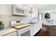 Modern kitchen with stainless steel appliances, white cabinets, and light countertops at 908 Whispering Trl, Greenfield, IN 46140
