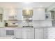 Bright kitchen showcases stainless steel appliances, white cabinetry, and mosaic tile backsplash at 908 Whispering Trl, Greenfield, IN 46140