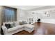 Bright living room features hardwood floors, a large window, and a comfortable sofa at 908 Whispering Trl, Greenfield, IN 46140