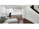 Spacious living room with hardwood floors, a cozy sofa, and natural light from nearby windows at 908 Whispering Trl, Greenfield, IN 46140