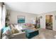 Bright living room with a large sofa, neutral carpet, and stylish decor at 908 Whispering Trl, Greenfield, IN 46140