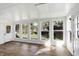 Charming sunroom with walls of windows providing panoramic views of the backyard at 908 Whispering Trl, Greenfield, IN 46140