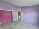 Bedroom with purple walls and an open closet with lots of space at 1017 Grovewood Dr, Beech Grove, IN 46107
