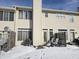Back exterior of property with deck and chairs, and a snowy yard at 1017 Grovewood Dr, Beech Grove, IN 46107