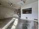 Open-concept living room area showing stairs, walls, and ceiling fan at 1017 Grovewood Dr, Beech Grove, IN 46107