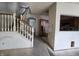 Open-concept living room area showing stairs, walls, and ceiling fan at 1017 Grovewood Dr, Beech Grove, IN 46107